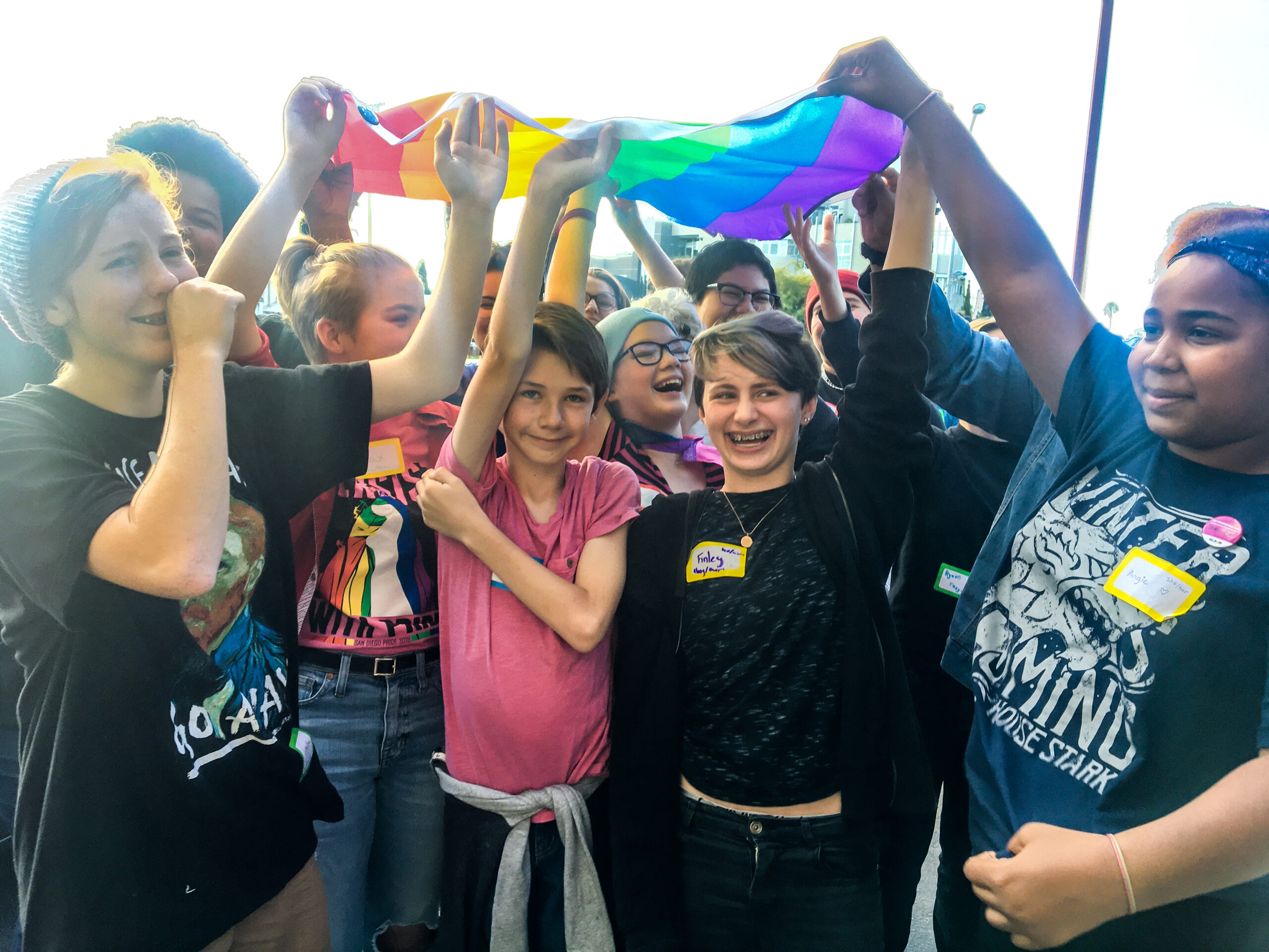 Youth holding rainbow flag