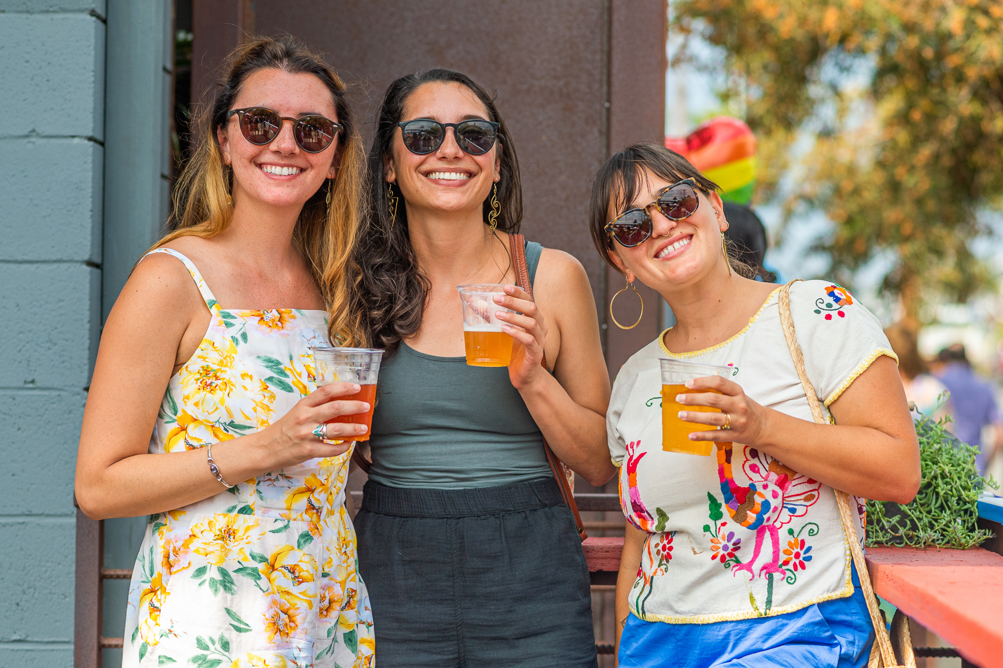 Group of people with sunglasses holding beers
