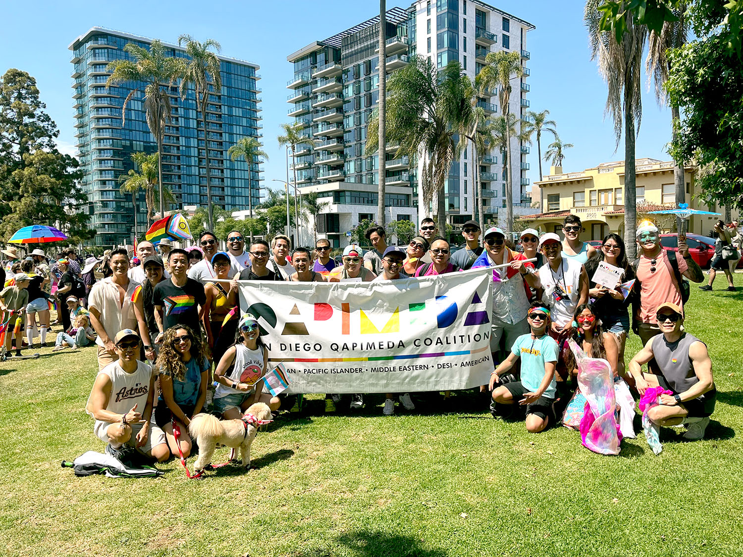 QAPIMEDA Coalition posing around banner outside in San Diego