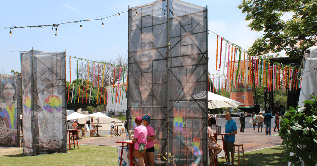 The Mundo Latino stage beautifully decorated with pillars of art and strings of flowers.