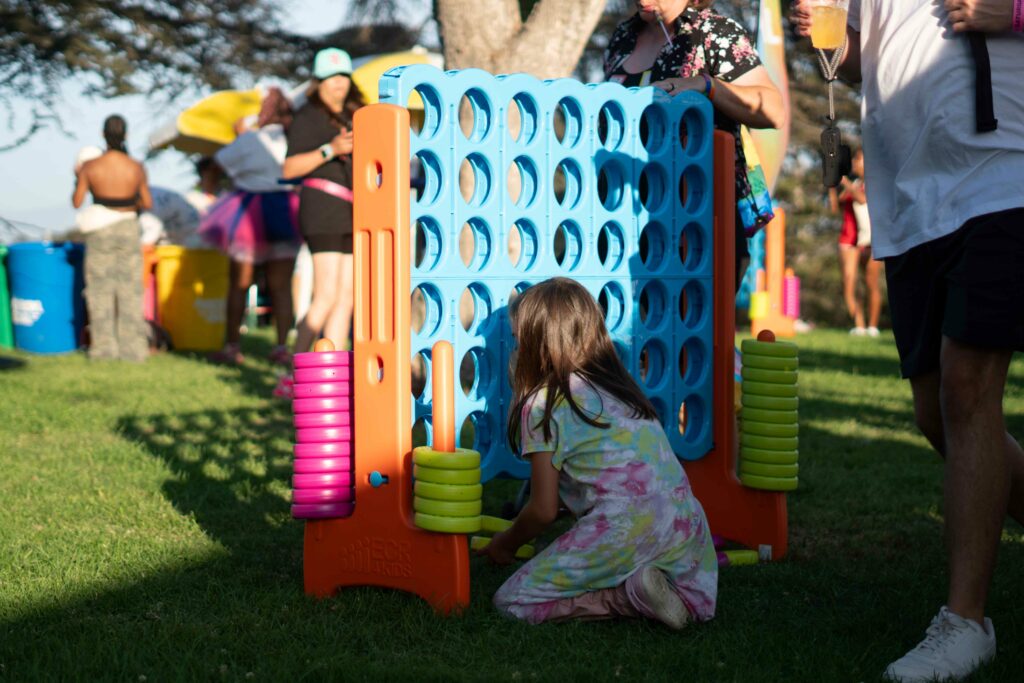 A child plays a game at San Diego Pride Festival 